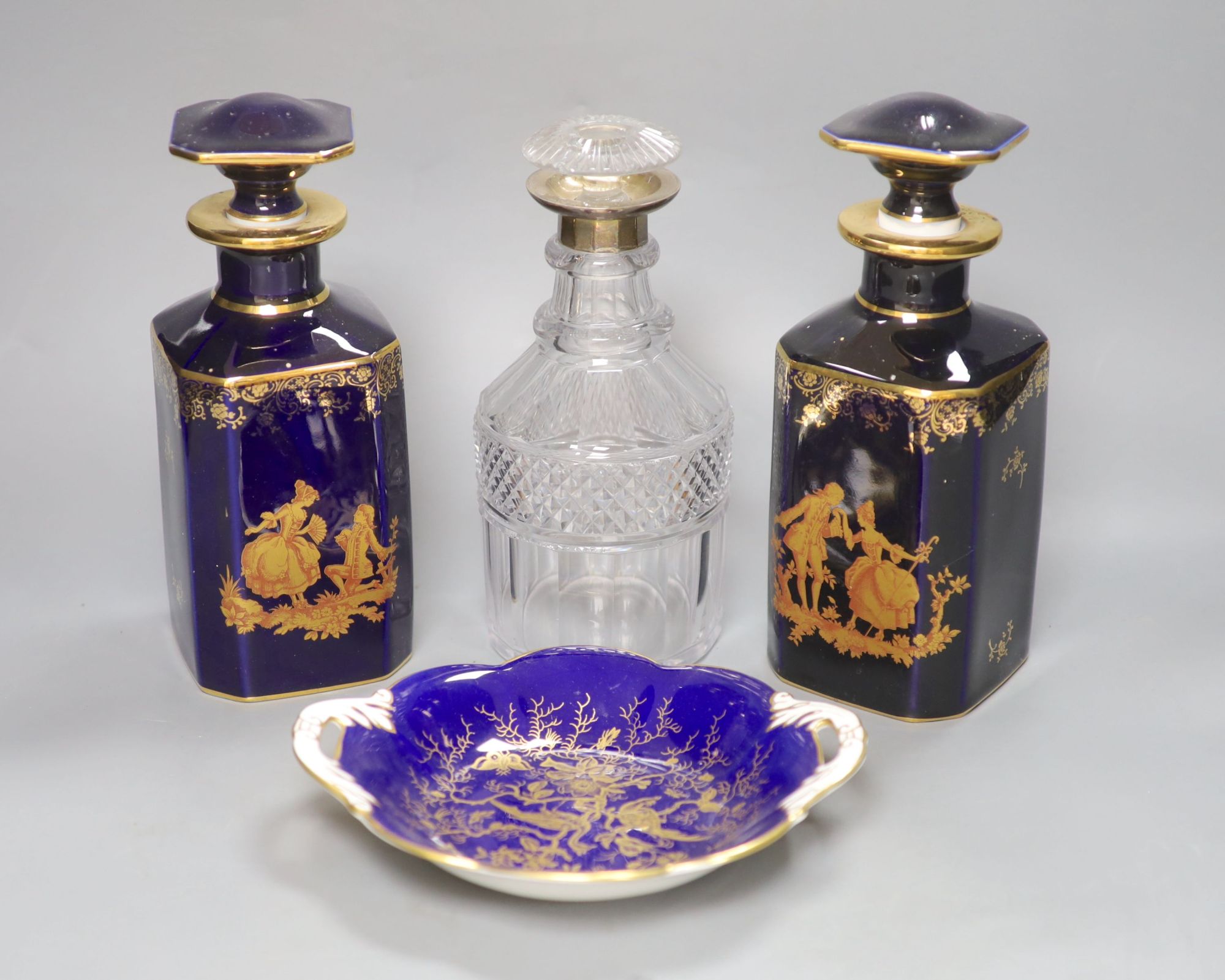 A pair of Limoges scent flasks, a silver mounted glass decanter and a Coalport dish, tallest 23cm